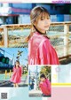 A woman in a pink dress standing on a train track.